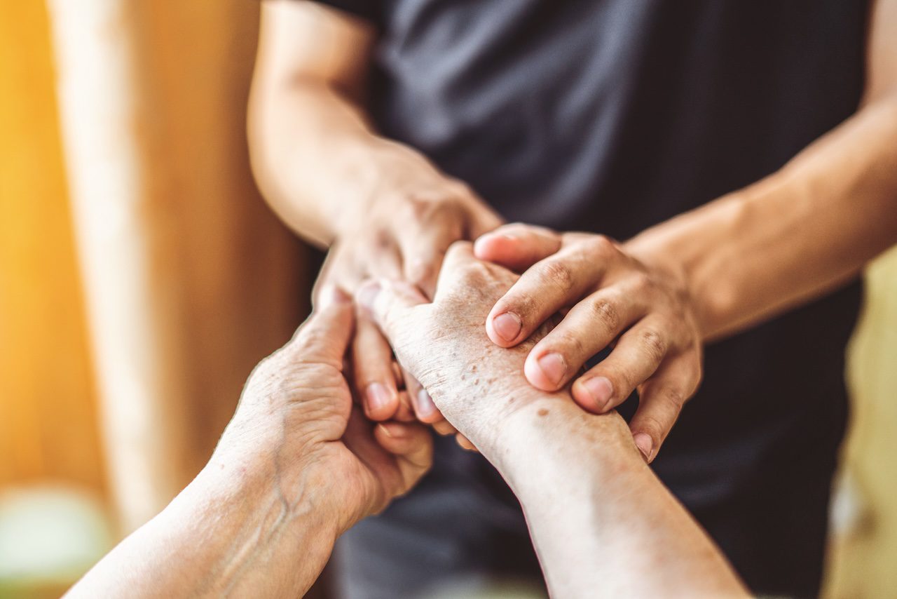 Two people holding hands